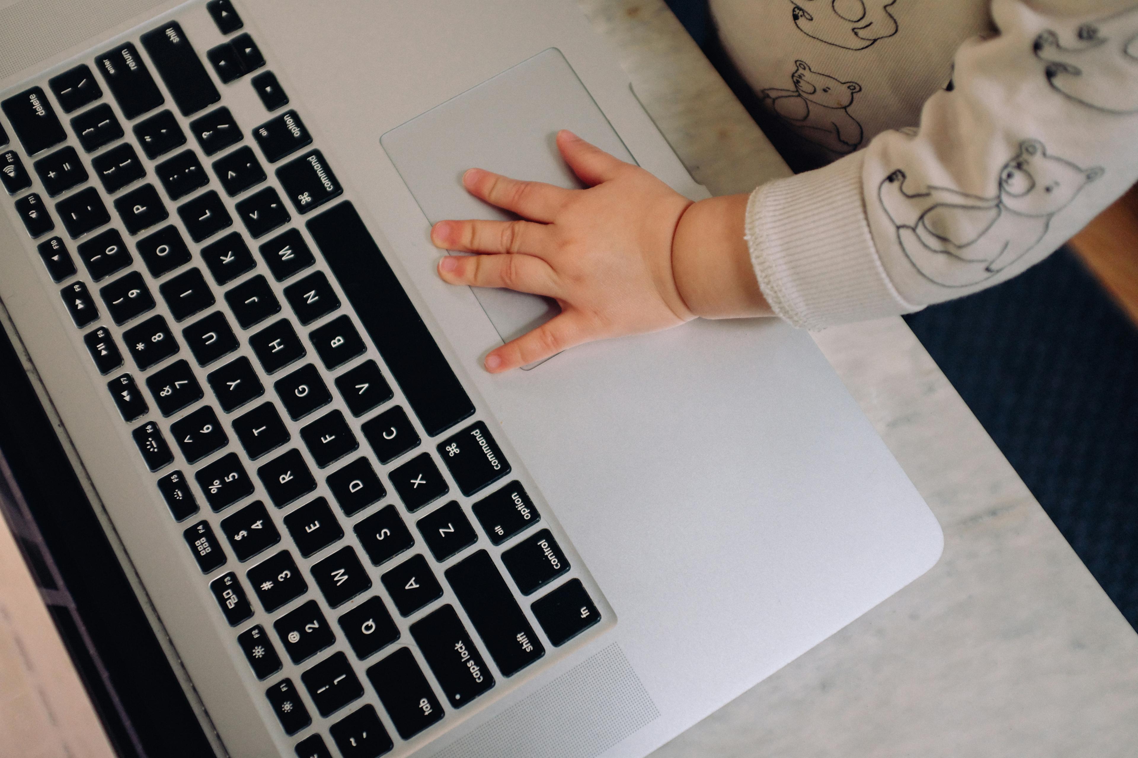 Baby hand on laptop