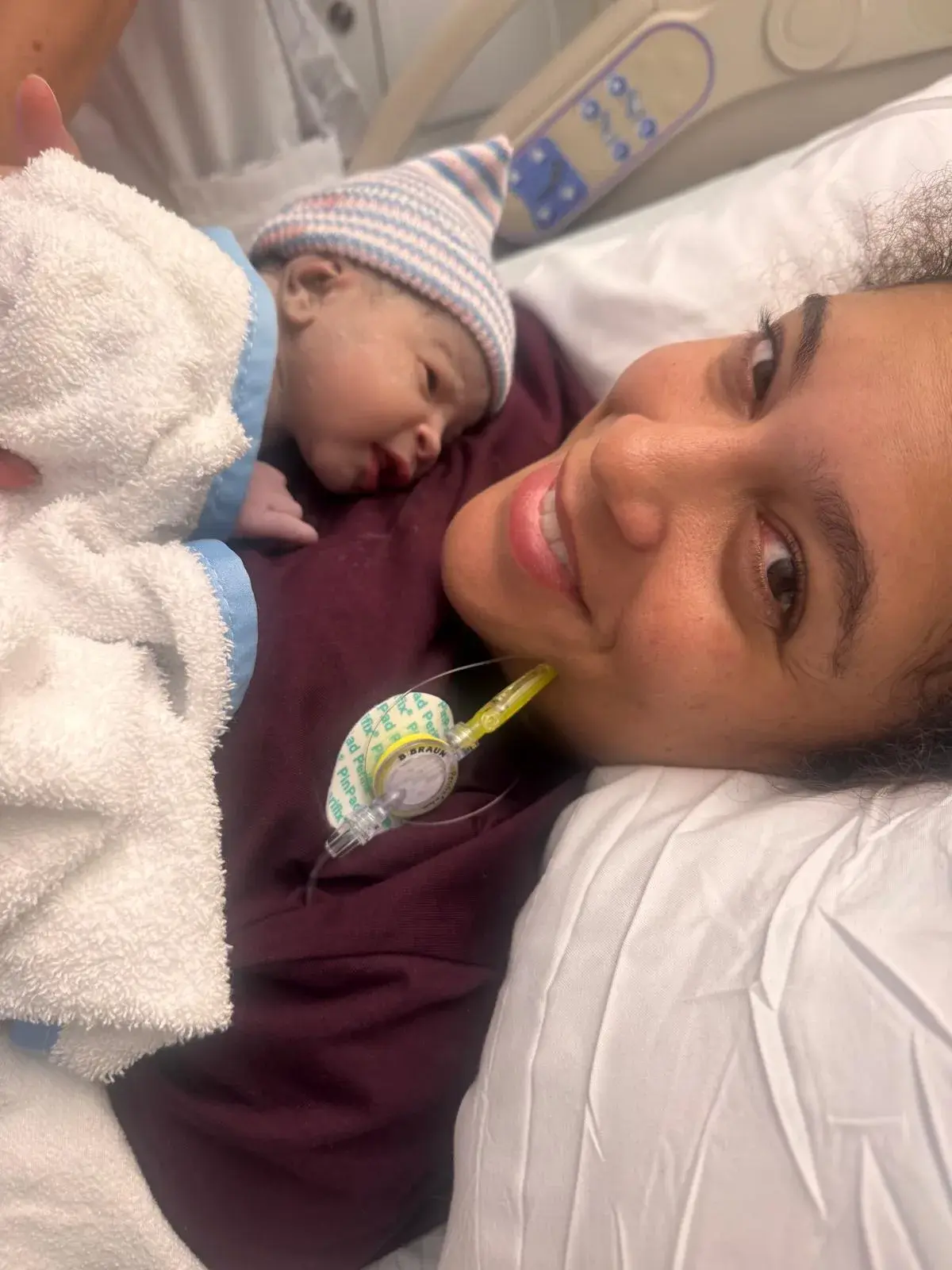 Kyle with her newborn daughter on her chest in the hospital