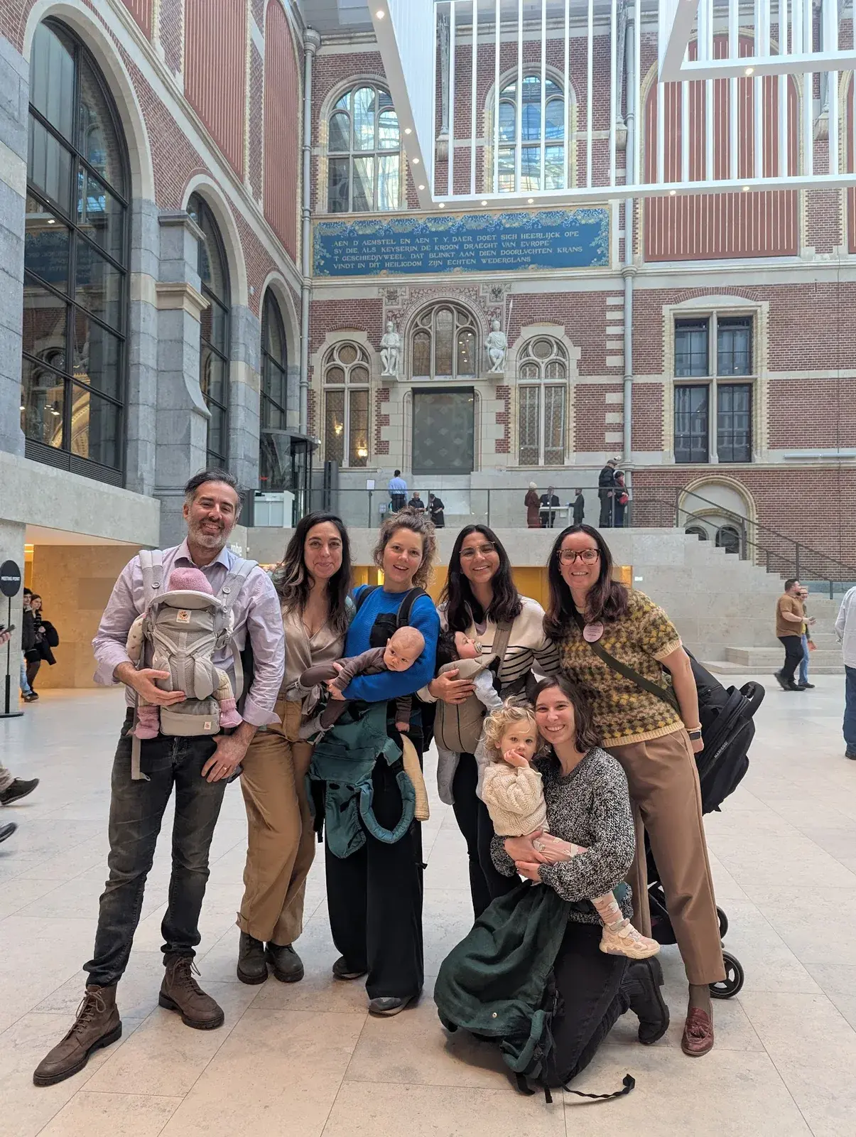 A group of parents and babies posing together at the Rijksmuseum