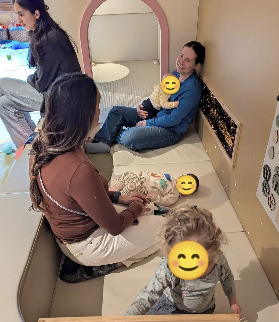 Parents and babies playing together in a soft playroom